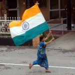 Indian woman runs with flag